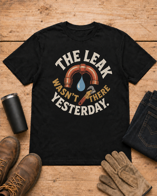 The Leak Wasn't There Yesterday Plumber T-shirt in Black workbench flat lay