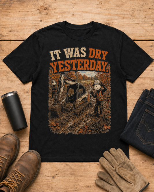 It Was Dry Yesterday. | Heavy Equipment T-Shirt in Black workbench flat lay
