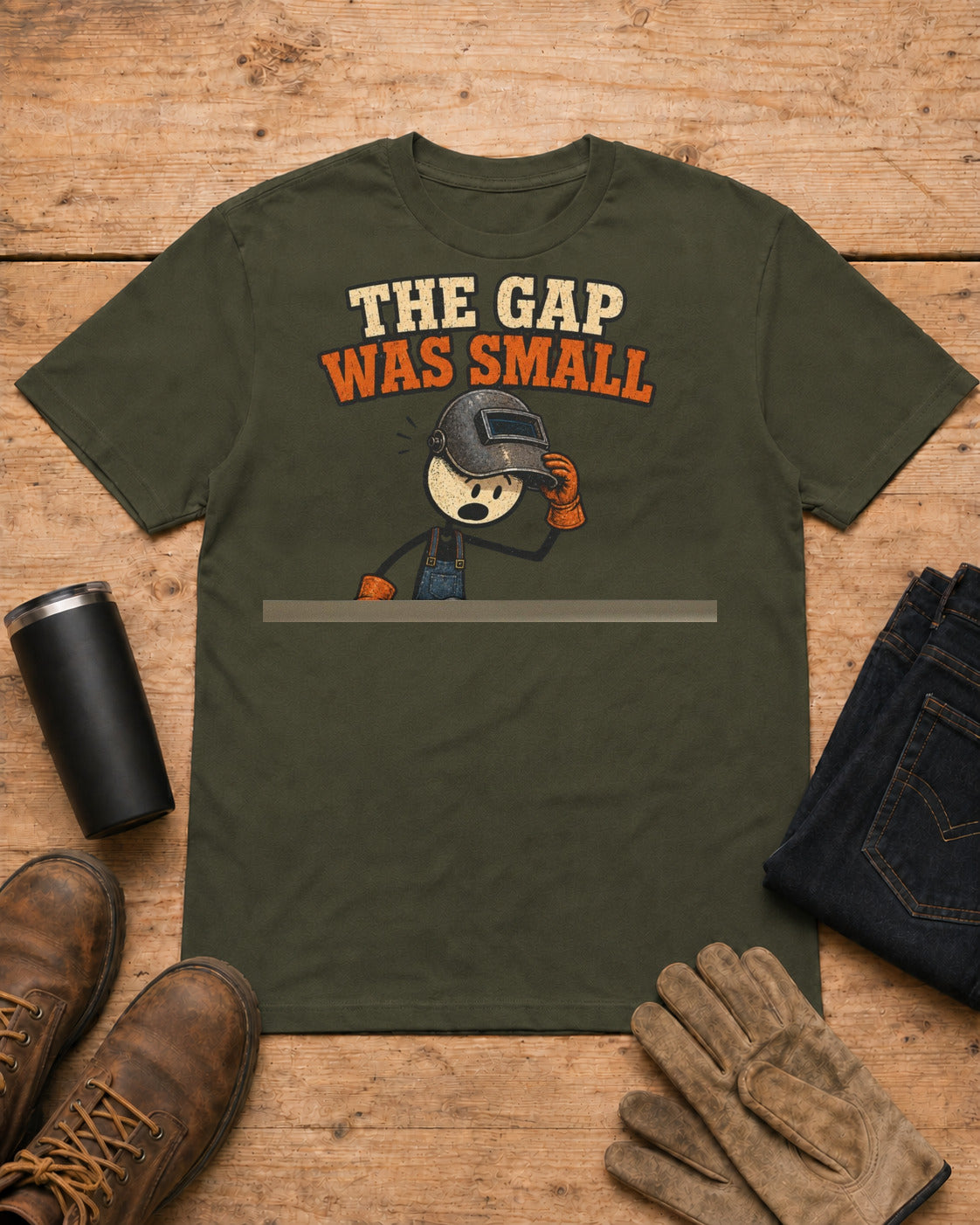 The Gap Was Small Funny Welder T-Shirt in Military Green workbench flat lay