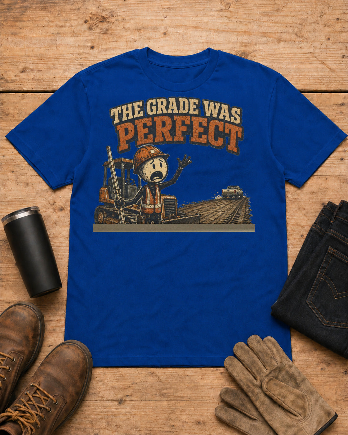 The Grade Was Perfect Heavy Equipment T-Shirt in Royal Blue workbench flat lay