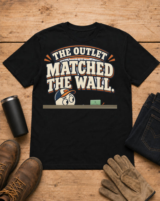 The Outlet Matched the Wall. Too Well. | Funny Electrician T-Shirt in Black workbench flat lay