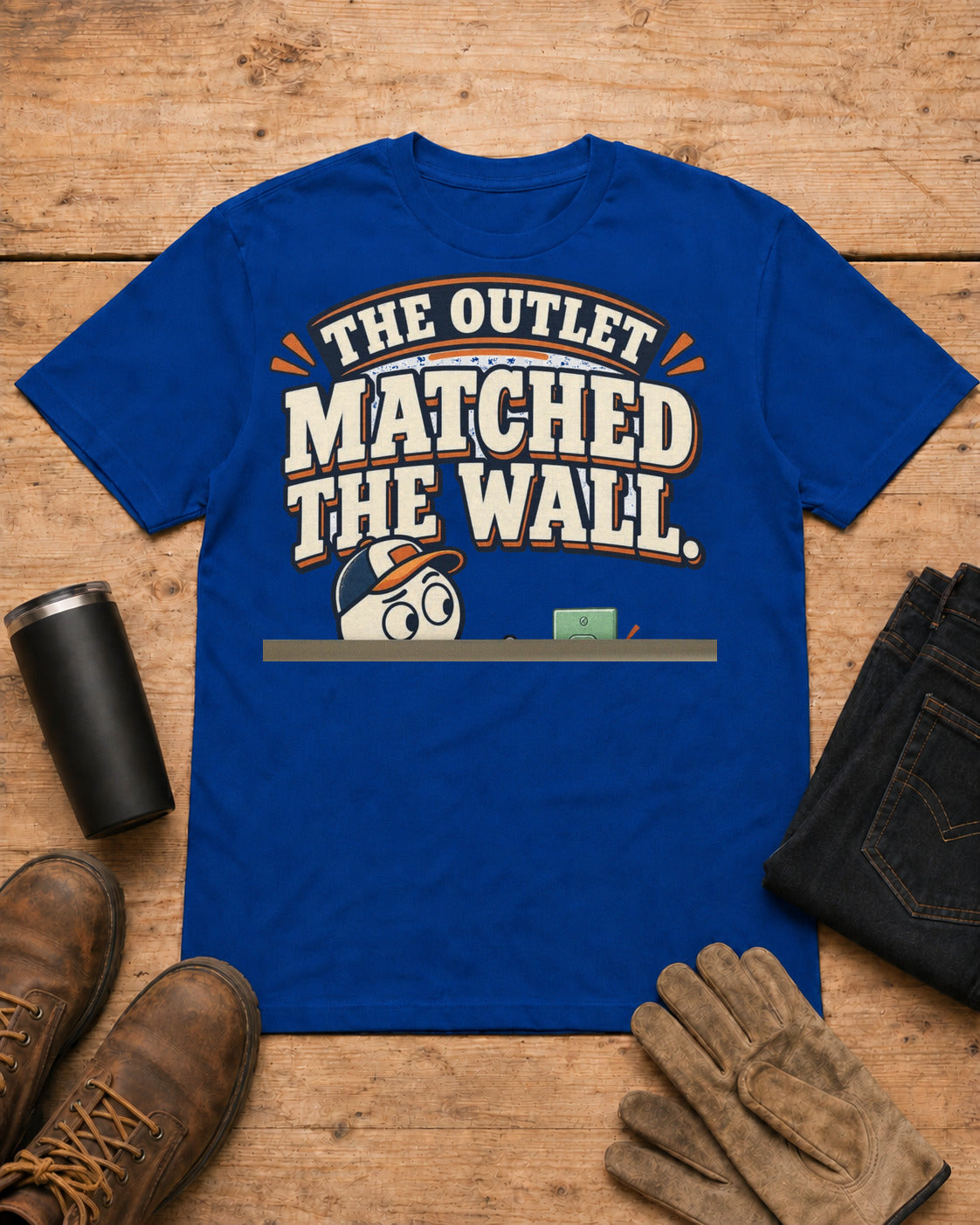The Outlet Matched the Wall. Too Well. | Funny Electrician T-Shirt in Royal Blue workbench flat lay