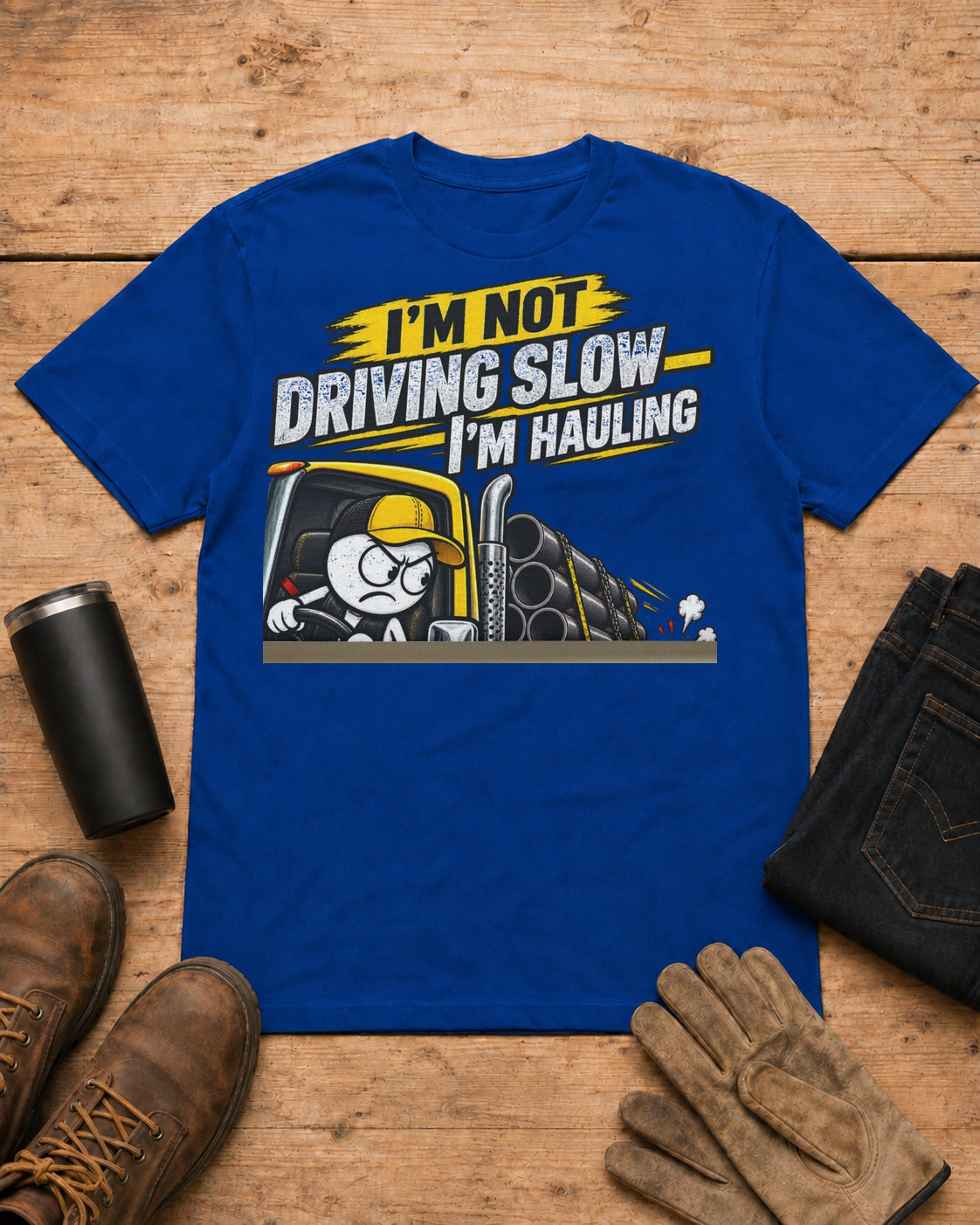 I’m Not Driving Slow—I’m Hauling 80,000 Lbs | Funny Truck Driver T-Shirt in Royal Blue workbench flat lay